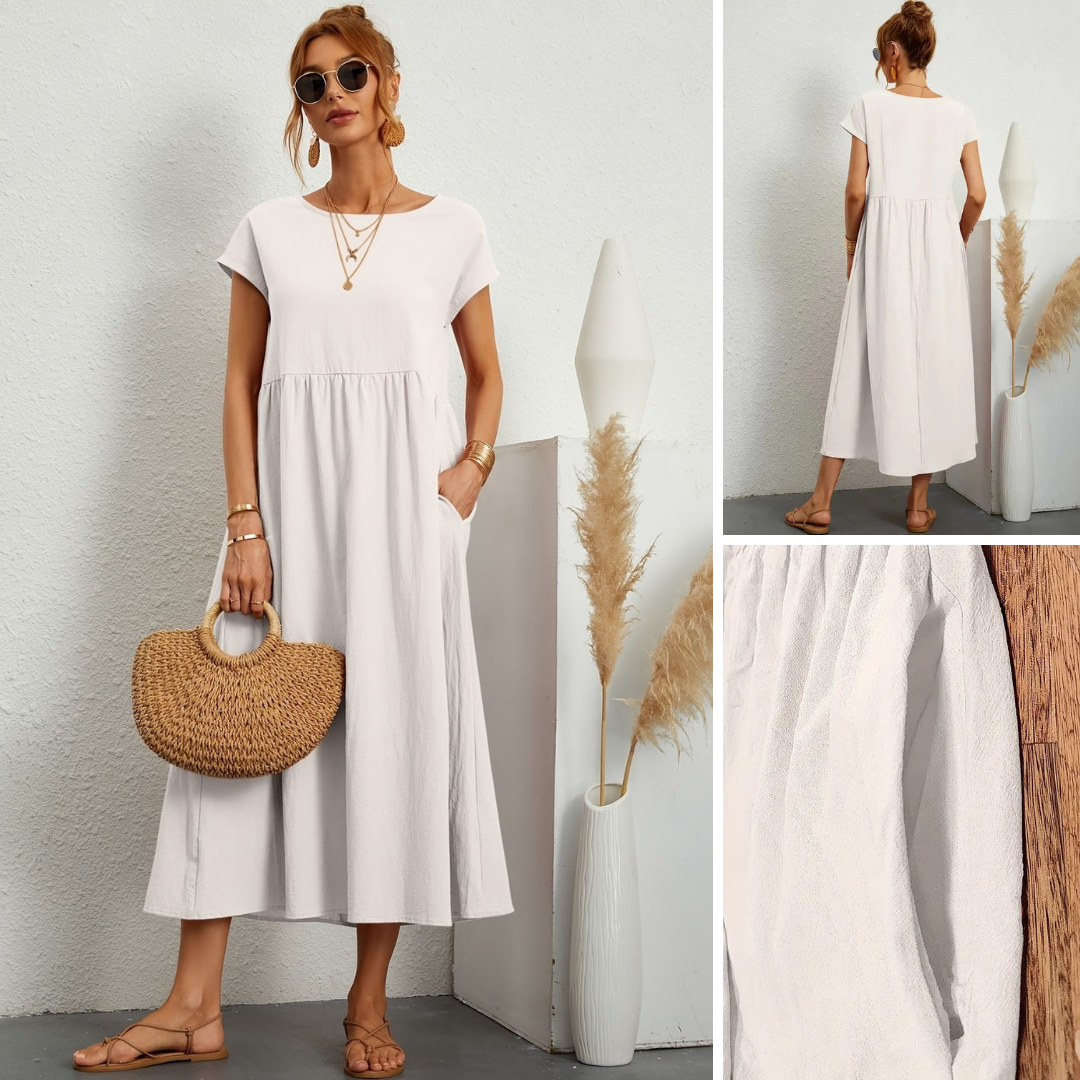 White smocked maxi dress with short cap sleeves and gathered tiered skirt, back view