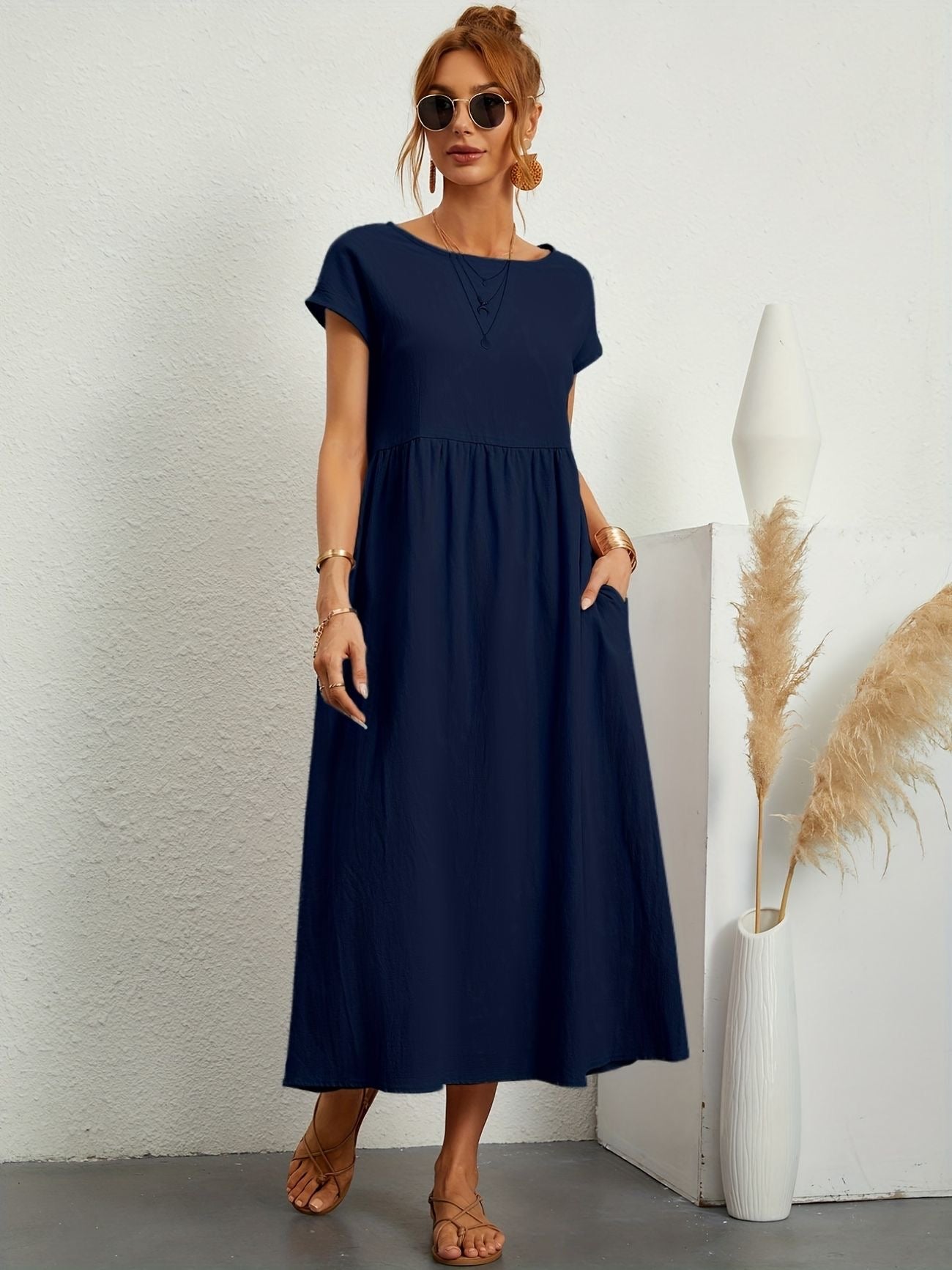 Navy maxi dress with gathered smocked bodice and short sleeves, loose A-line
