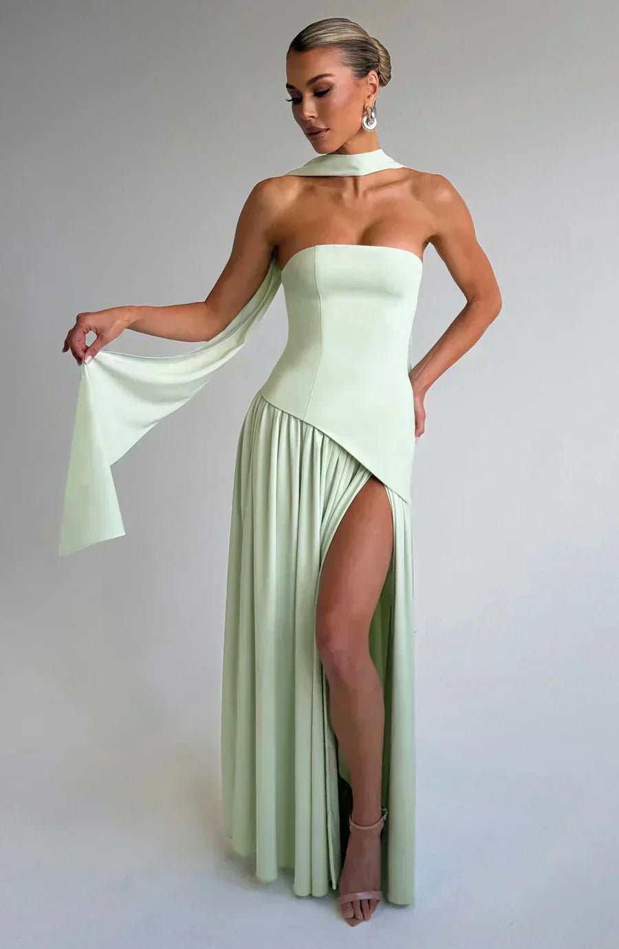 Sage green strapless maxi dress with cape-like overlay and thigh-high front slit