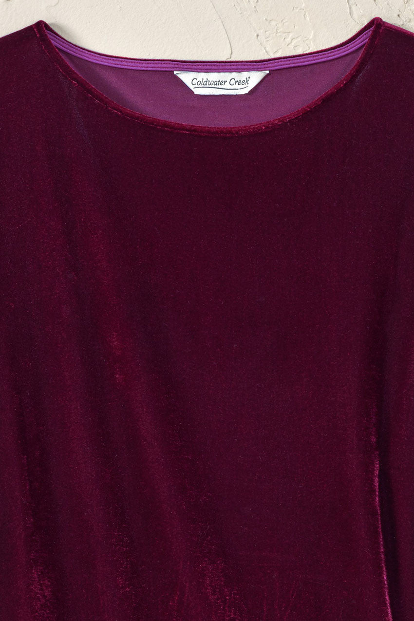 Purple velvet tunic top with crew neck and smooth velvet sheen, three-quarter sleeves.
