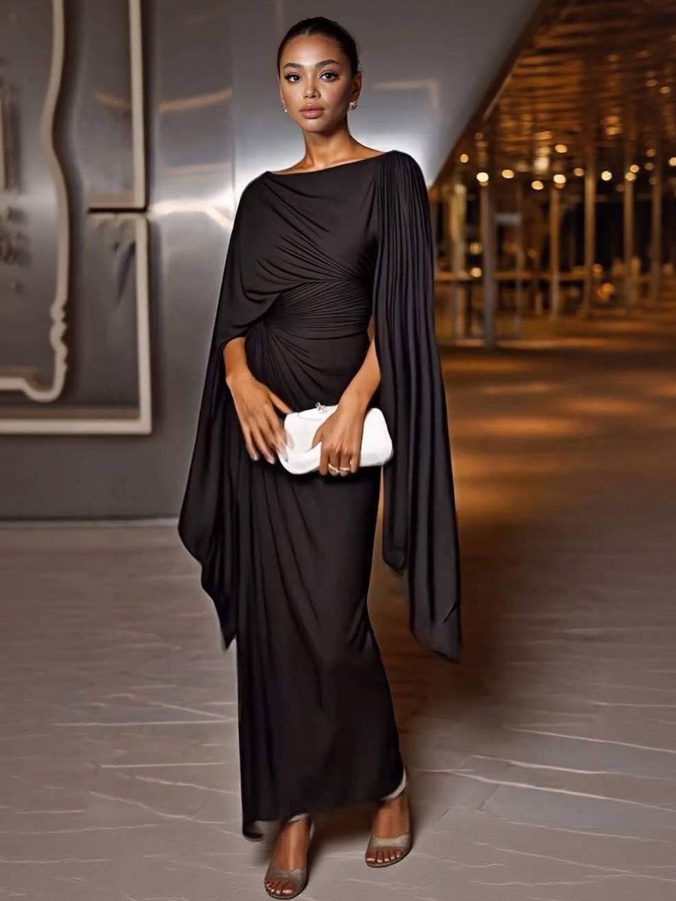 Dark chiffon maxi dress with boat neck, ruched waist, and flowing cape sleeves