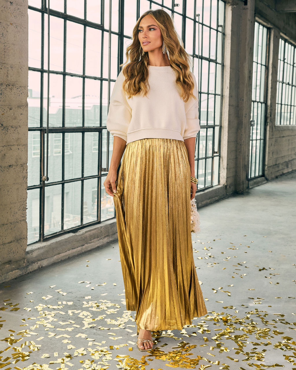 Cropped crewneck sweater in cream with ribbed neckline, hem, and sleeves.
