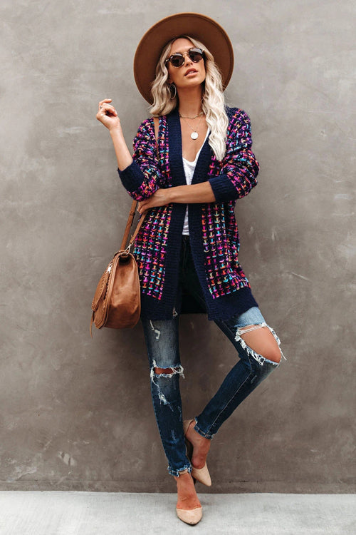 Purple-and-navy multicolor knit cardigan with open front and long sleeves over jeans