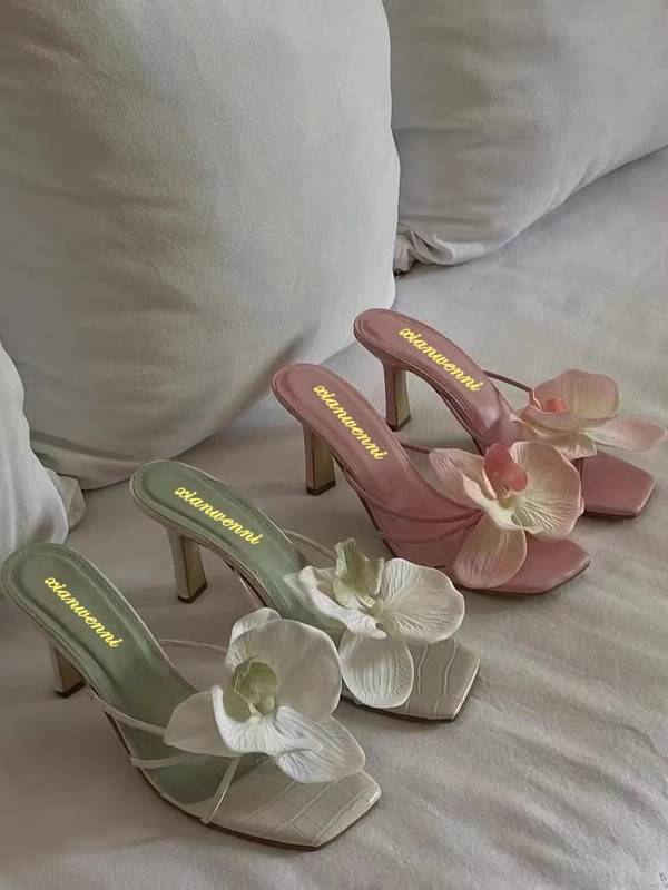 Satin stiletto mule heels with 3D orchid appliqué in green, white, and pink