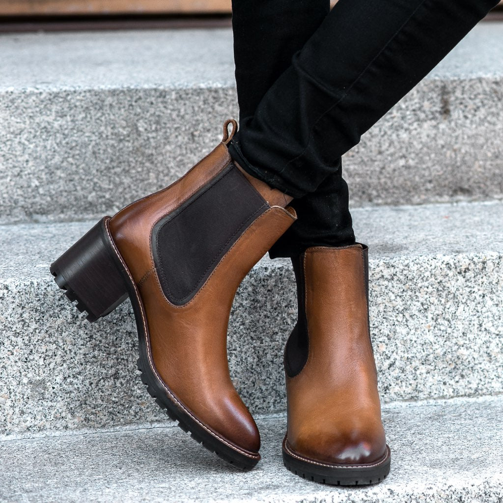 Brown chelsea boots worn with black pants, dark elastic panels, chunky sole