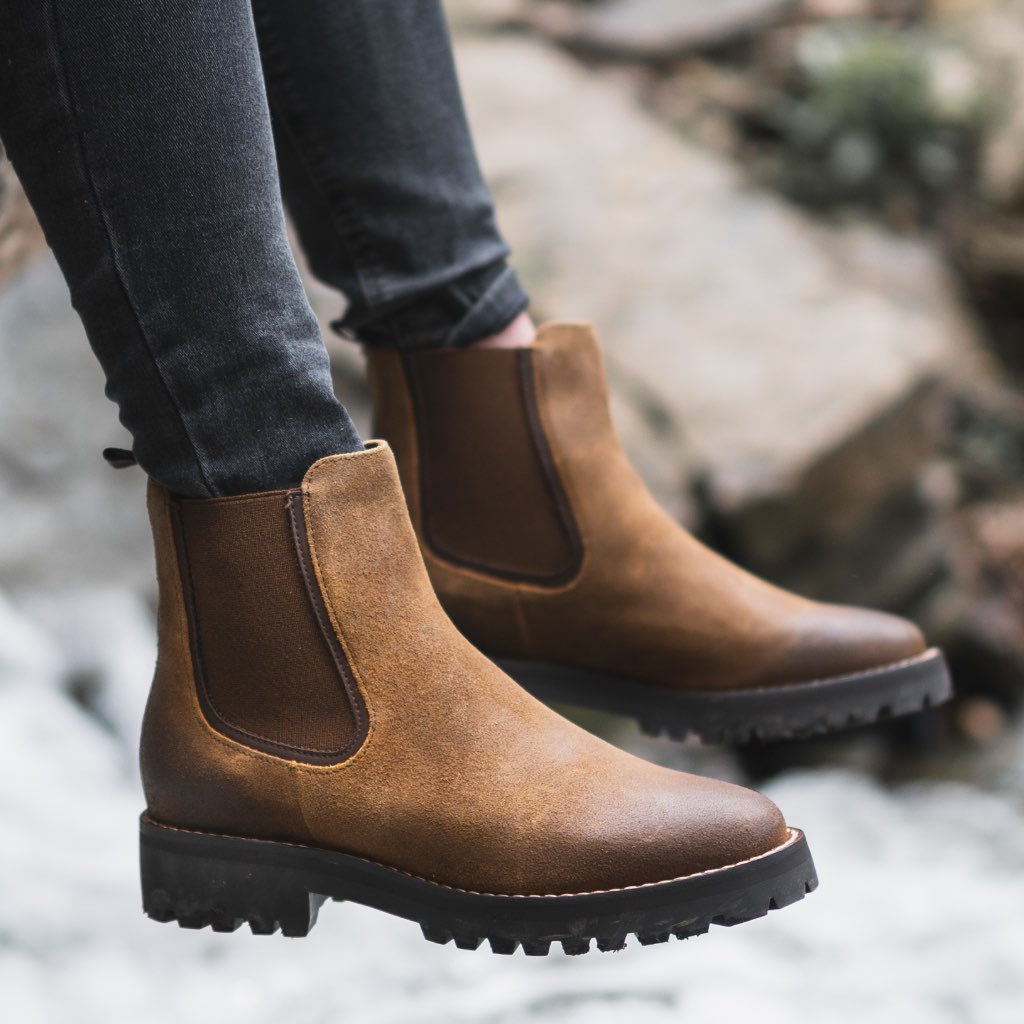 Brown suede Chelsea boot worn with dark jeans, elastic gore and lug outsole