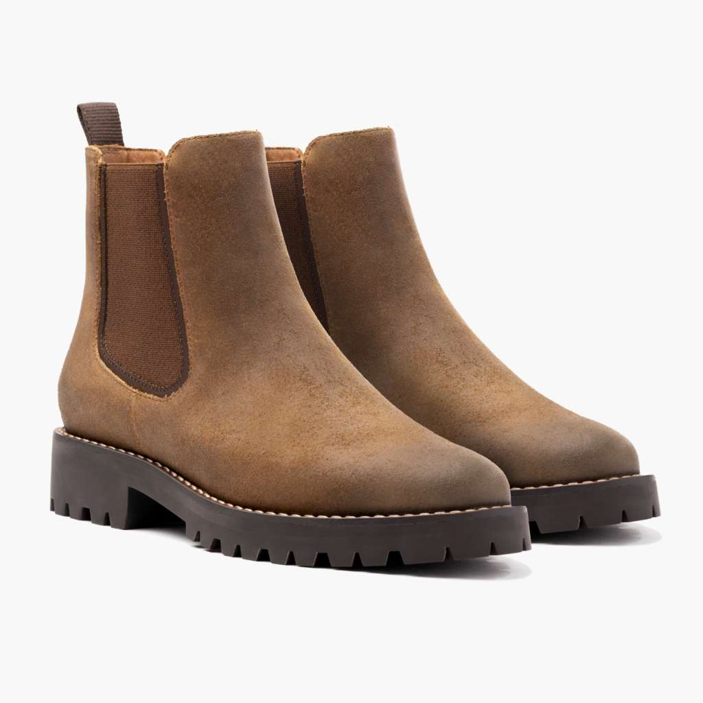 Pair of brown suede ankle Chelsea boots with elastic gore and dark tread sole