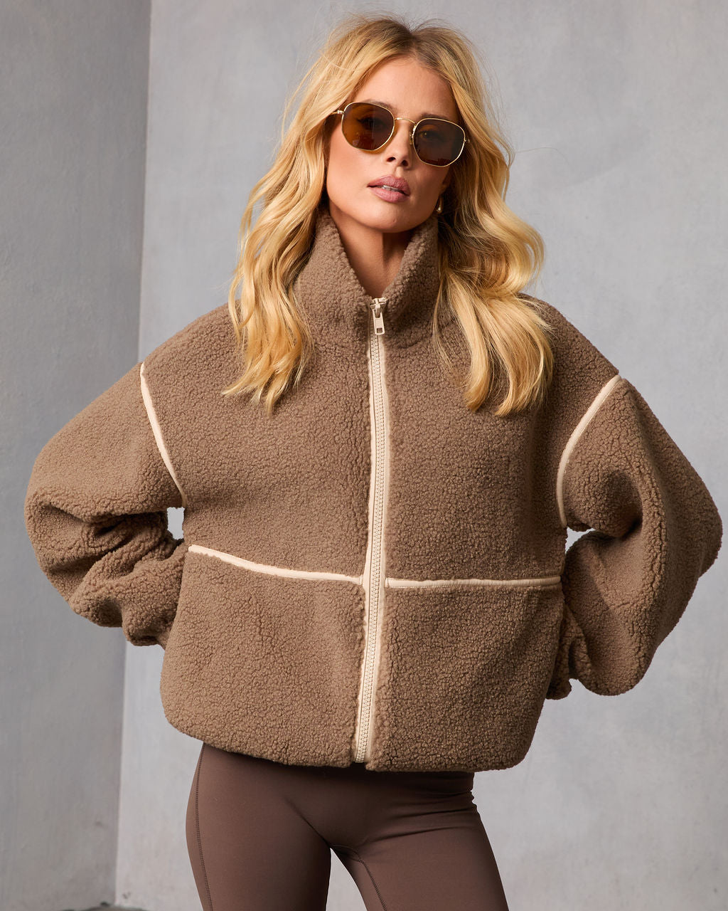 Brown shearling jacket with off-white contrast trim and center front zip