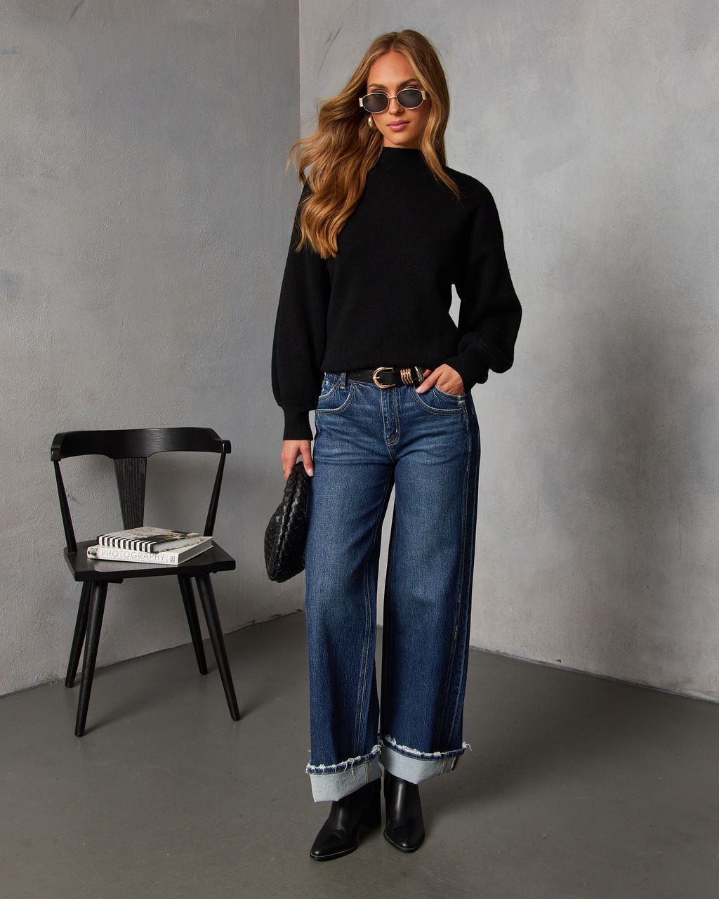Black mock neck sweater with long sleeves and ribbed cuffs, relaxed fit.