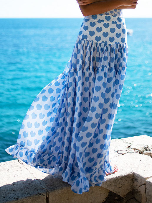 Blue heart-print strapless tiered ruffle maxi skirt with gathered texture at waist.