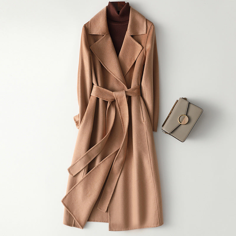 Women’s tan long wool-cashmere coat with notched lapels and waist belt.