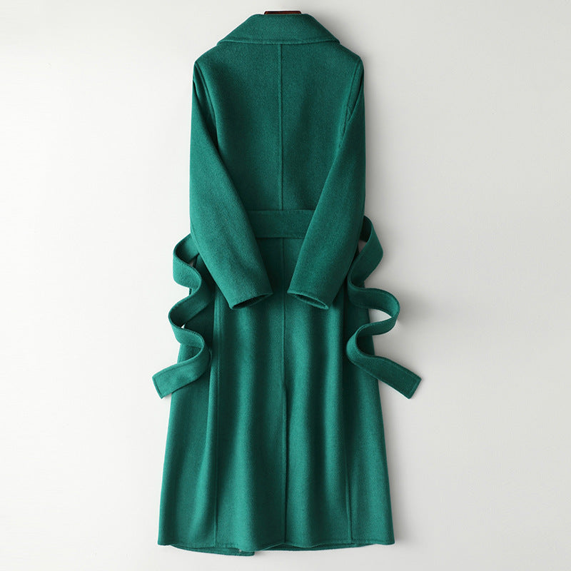 Women’s green long wool-cashmere coat, back view with tied waist belt.