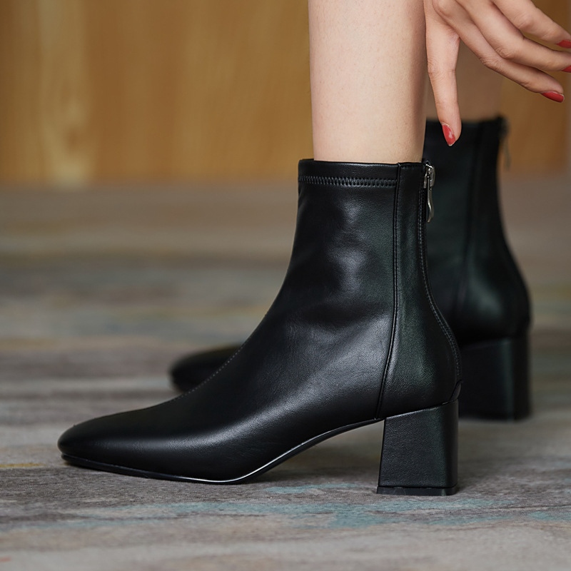 Women’s black square-toe ankle boots with block heel and side zipper, leather-look sock bootie.