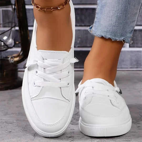 Women’s white chunky platform lace-up sneakers in faux leather, heel and toe view on feet.
