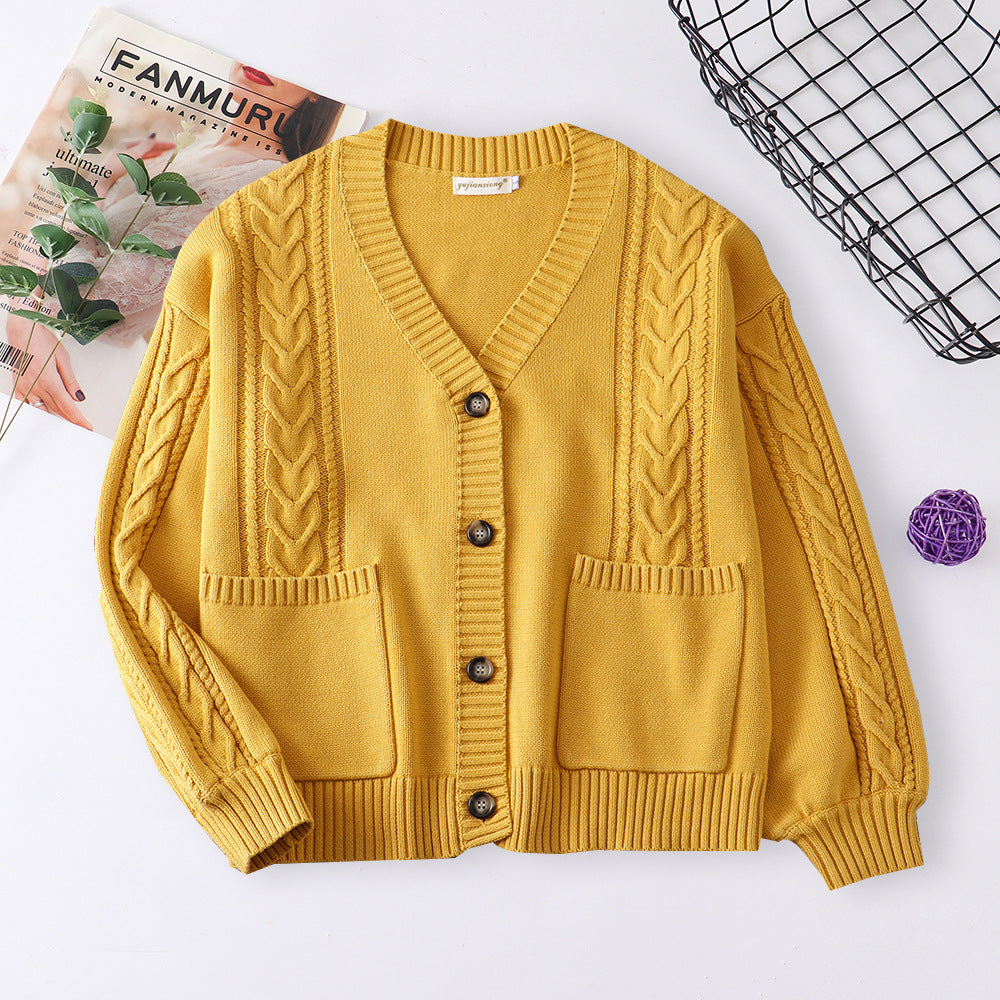 Women’s cable knit cardigan in mustard yellow with V-neck button front and patch pockets