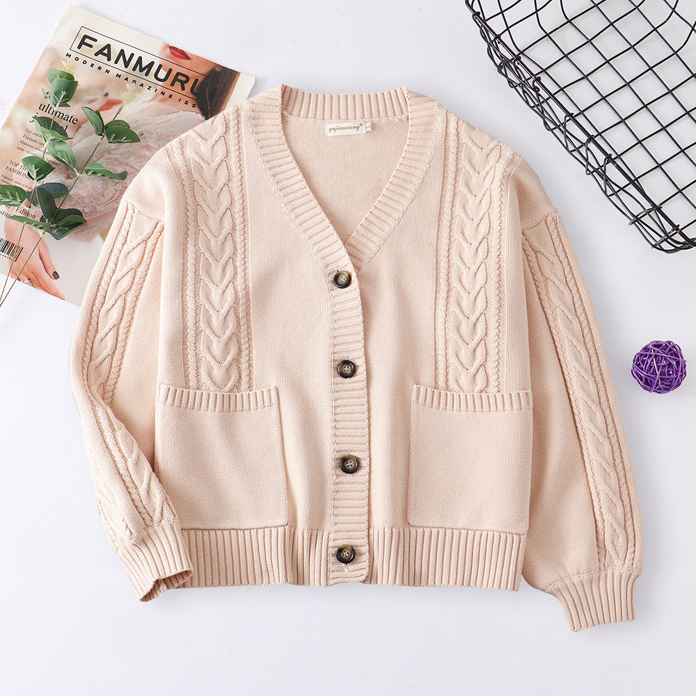 Women’s cable knit cardigan in cream with V-neck button front and patch pockets