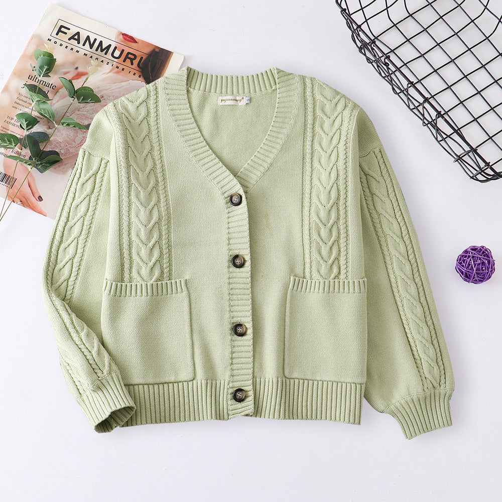 Women’s cable knit cardigan in light green with V-neck button front and patch pockets