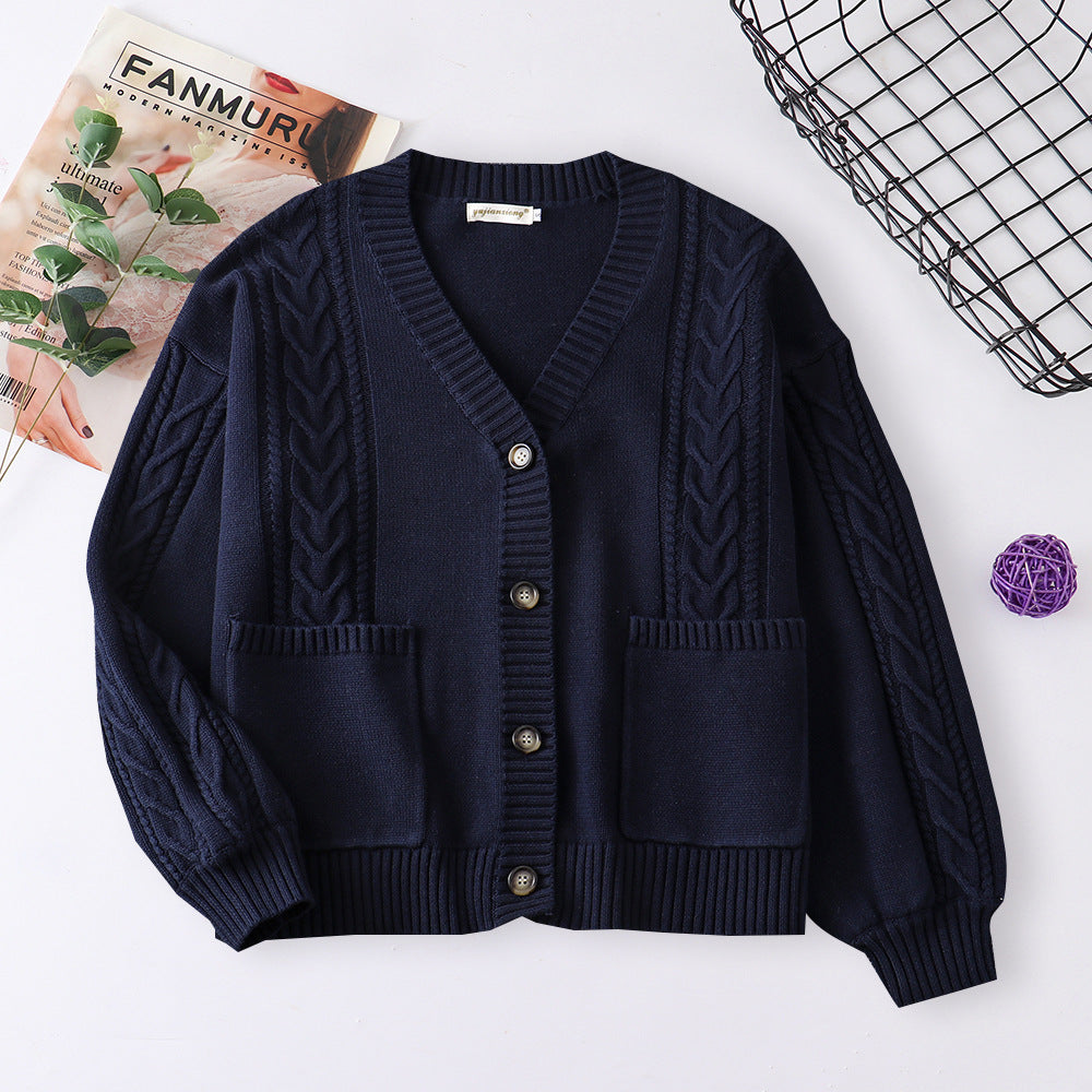 Women’s cable knit cardigan in navy blue with V-neck button front and patch pockets