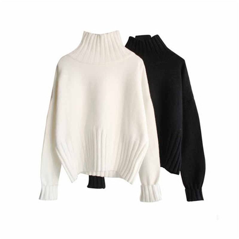 Women's white and black knit half-turtleneck sweaters with ribbed cuffs on hangers