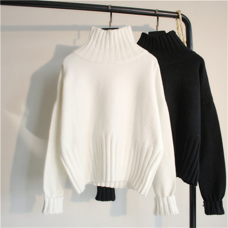 Women's white knit half-turtleneck sweater with loose drape and ribbed cuffs