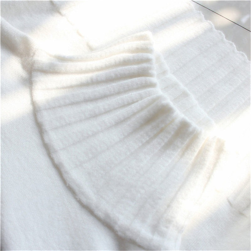 Women's white knit half-turtleneck with ribbed neckline and textured stitch detail