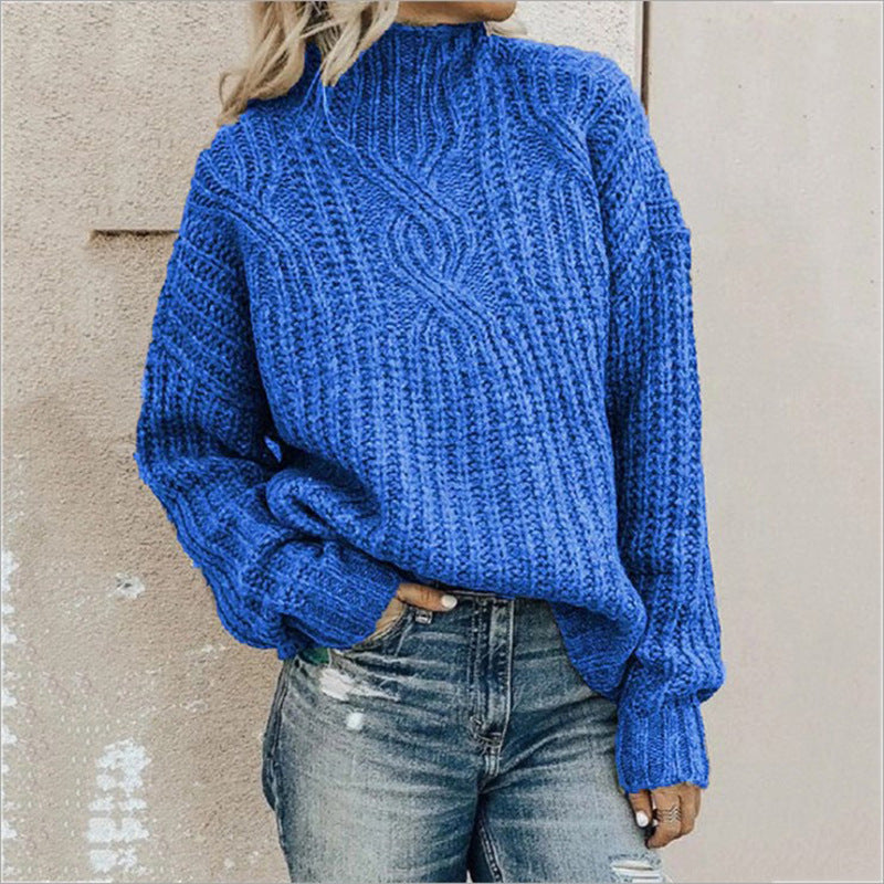 Women's blue cable knit turtleneck sweater with long sleeves and ribbed cuffs