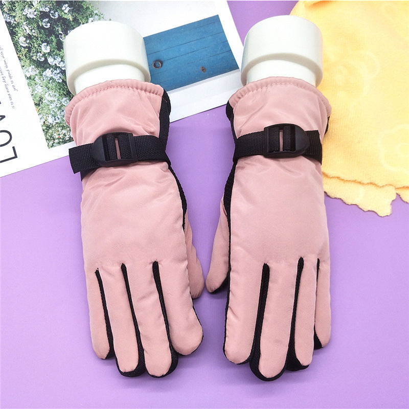 Thick winter ski gloves in light pink with black wrist strap and padded fingers