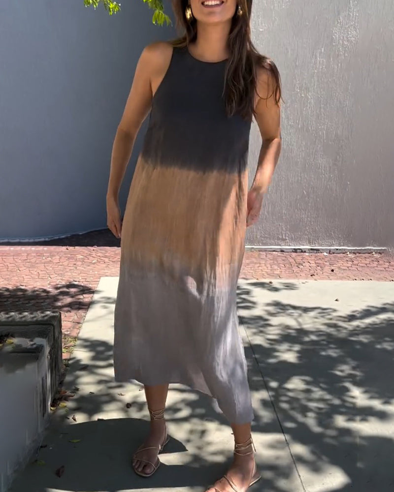 Sleeveless ombre midi dress with crew neck and side slit, dark-to-gray gradient, standing view.
