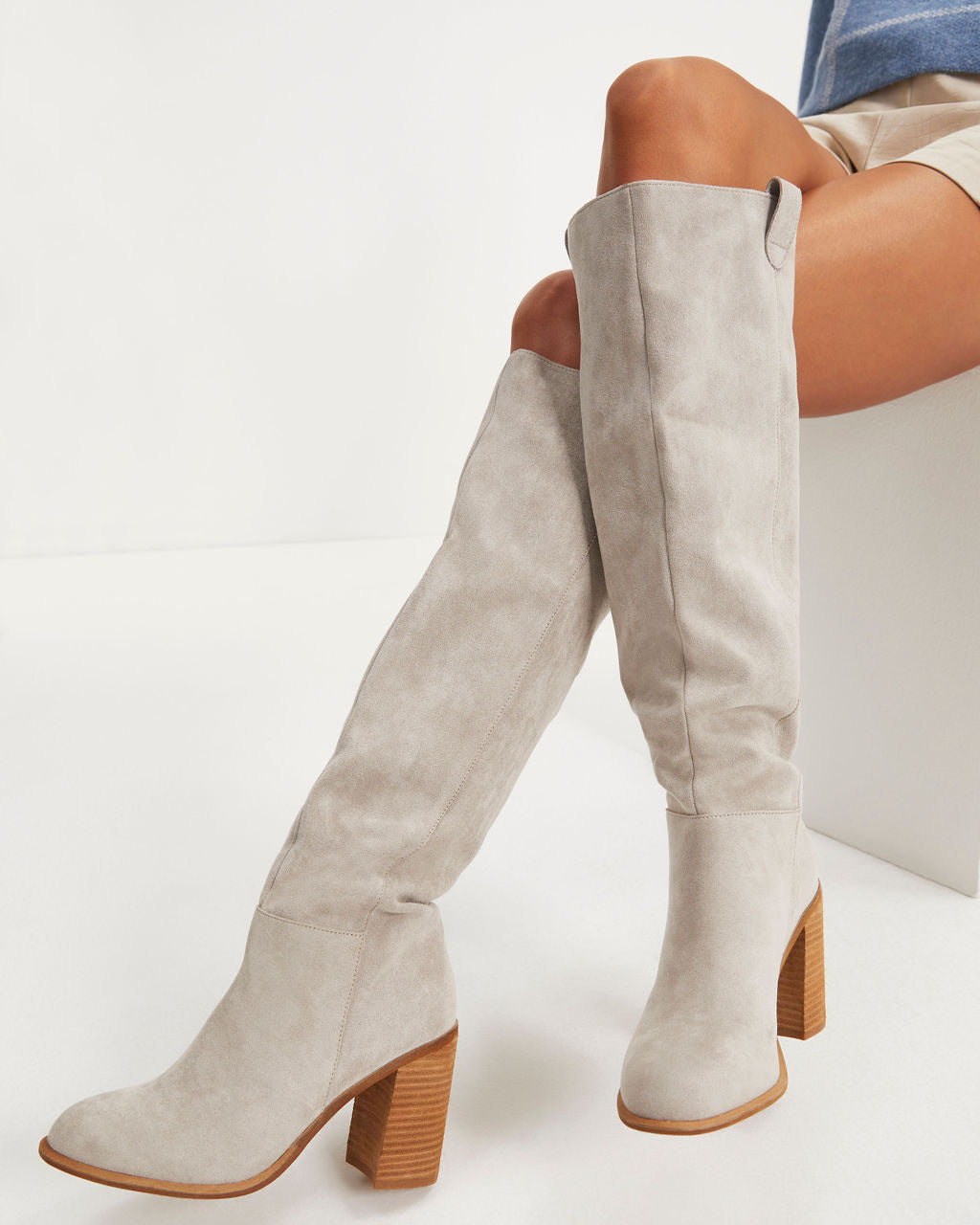 Light grey slouch boots with square toe and block heel, worn