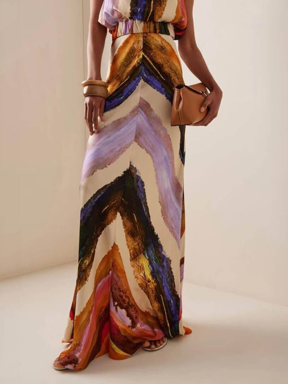 Abstract print satin maxi dress with flowing skirt and halter bodice, multicolor waves