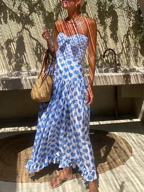 Blue heart-print strapless maxi dress with tiered ruffle skirt and ruched bodice.