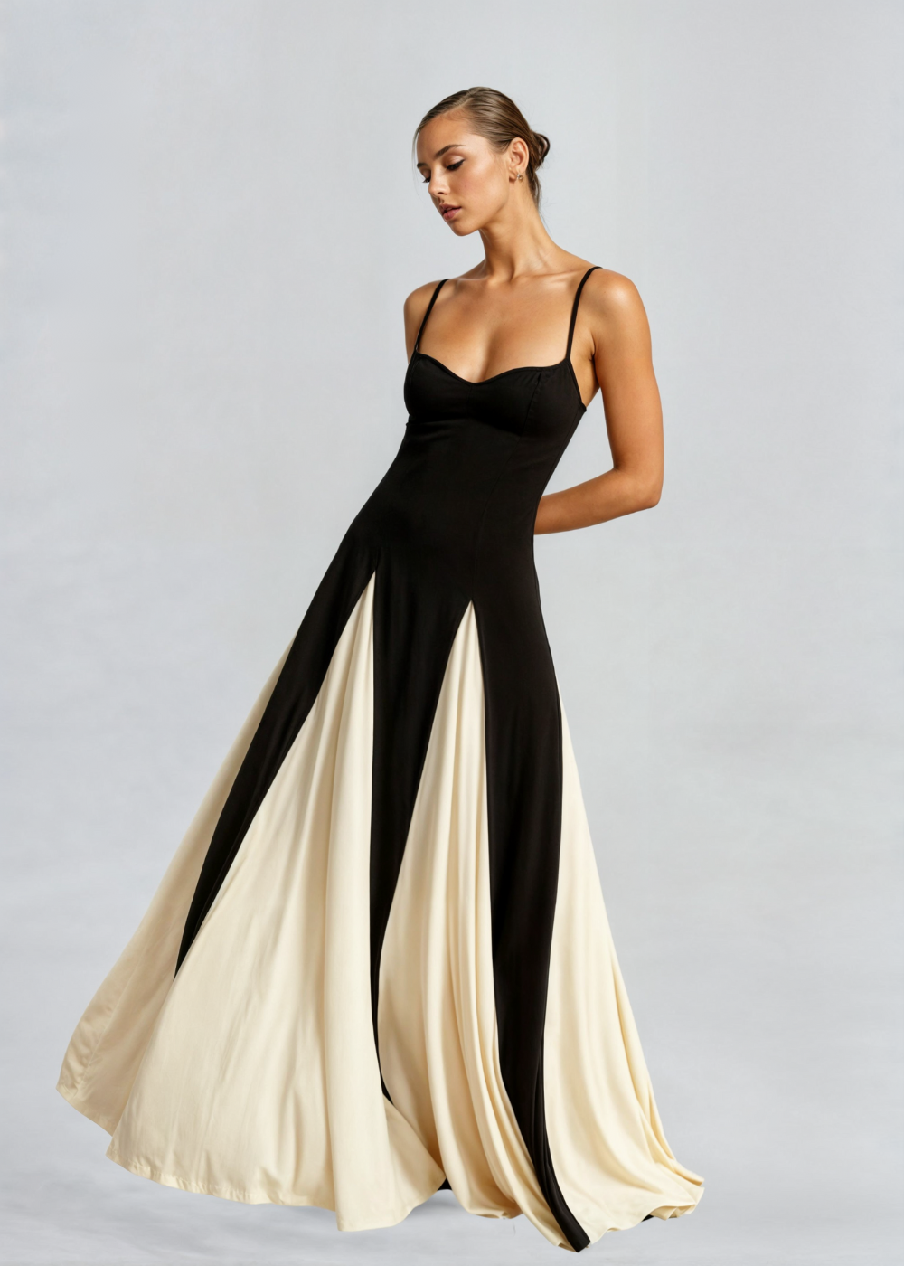 Black satin maxi dress with thin straps and sweetheart bodice; flowing cream-and-black panels