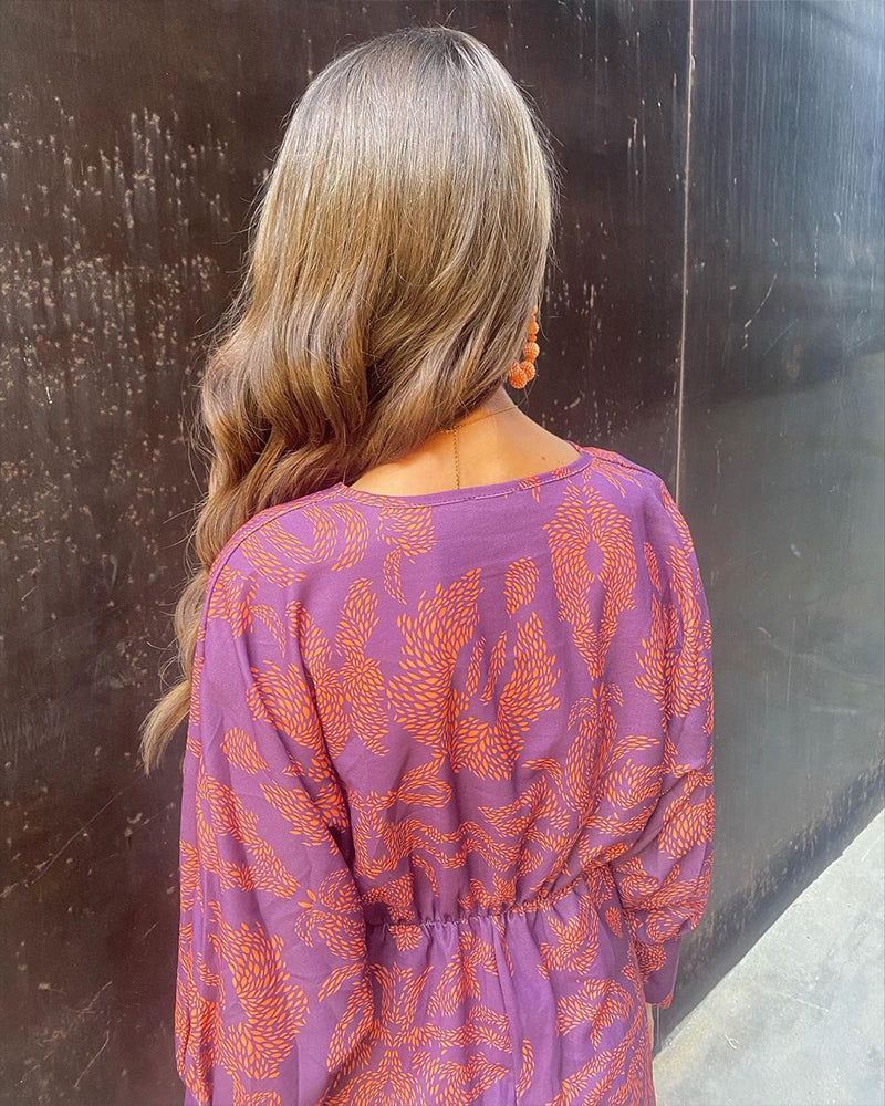 Purple midi dress, long sleeves, botanical print, twist-front detail on back view