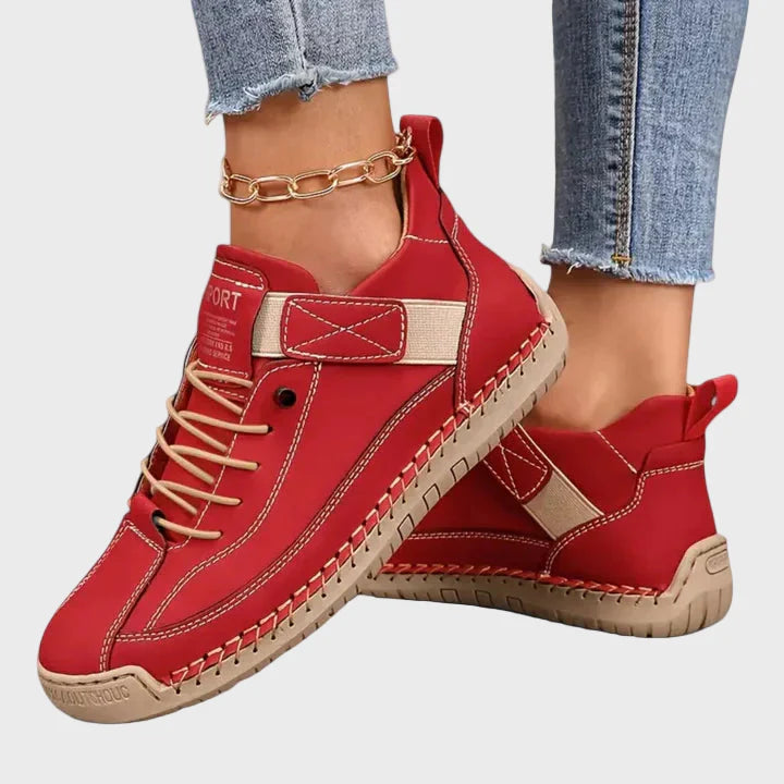 Red faux leather lace-up sneakers with ankle strap and beige rubber sole