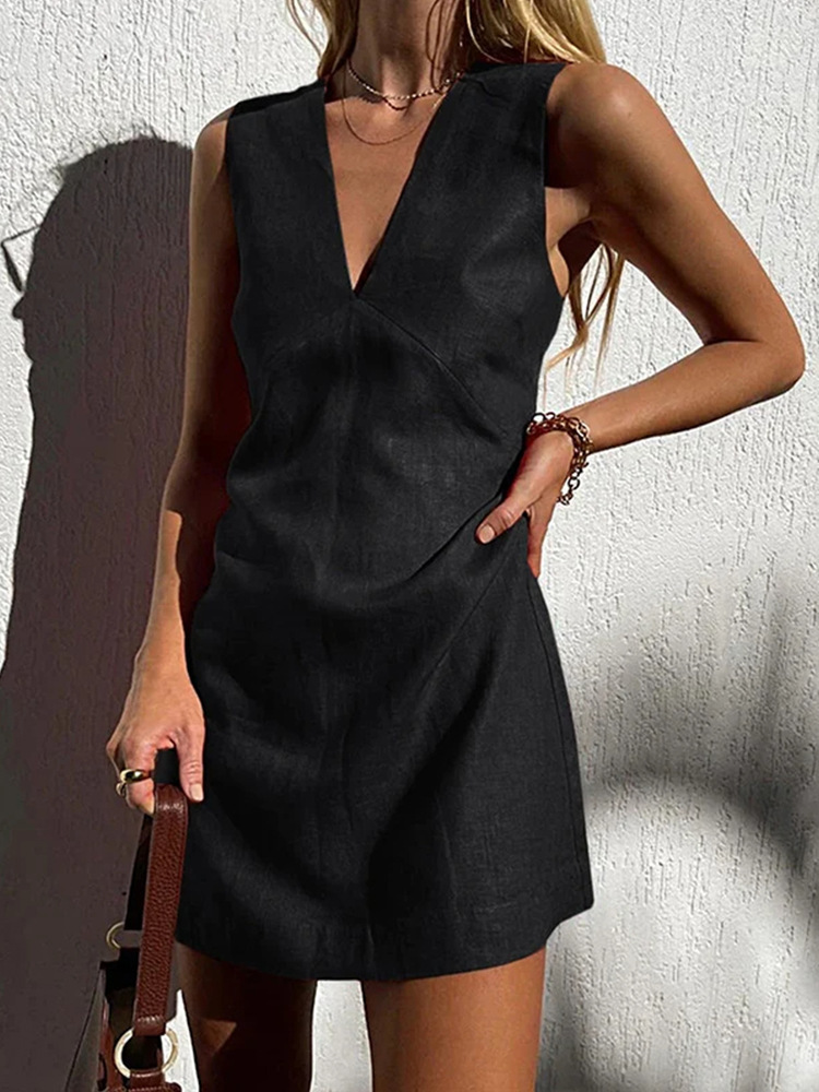 Sleeveless black mini dress with deep V neckline and seam panel detail