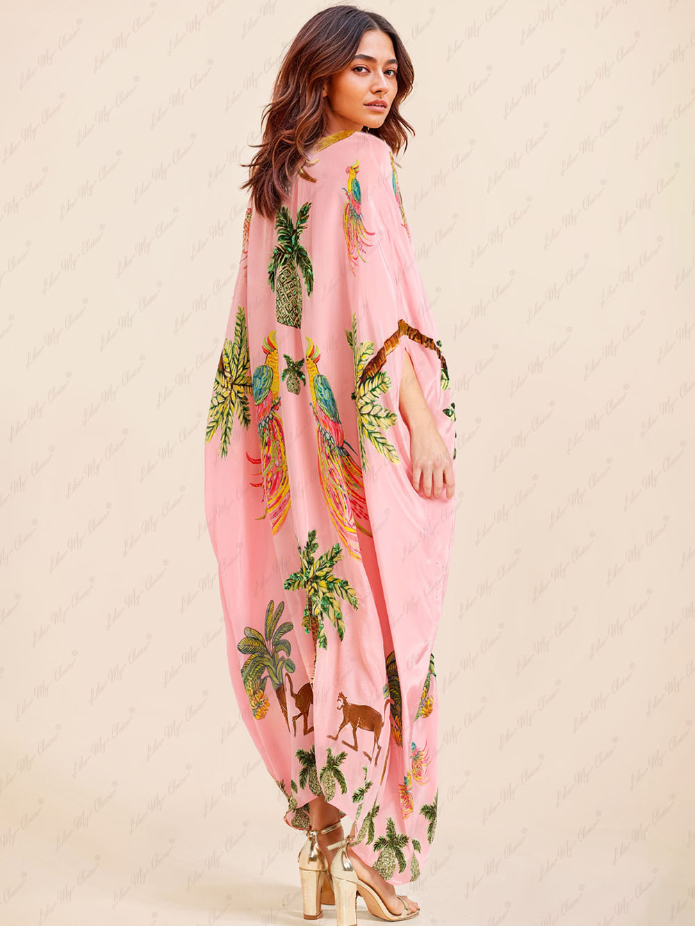 Pink tropical print kaftan maxi dress, side view with gold sequin V-neck trim.