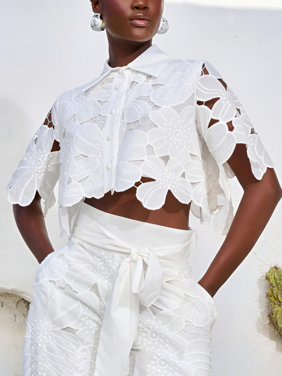 White lace blouse with floral cutwork and short sleeves, button-front detail