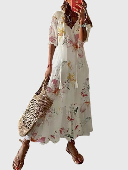 White boho summer dress with short sleeves and soft floral print, tiered skirt