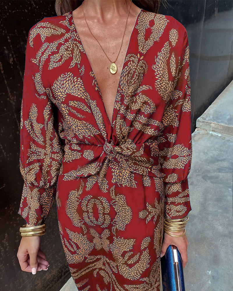 Red viscose midi dress close-up, deep V-neck twist-front, botanical print pattern