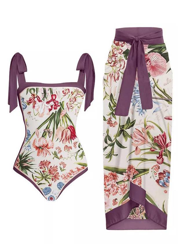 Purple one-piece swimsuit with tie straps and floral print; matching wrap sarong