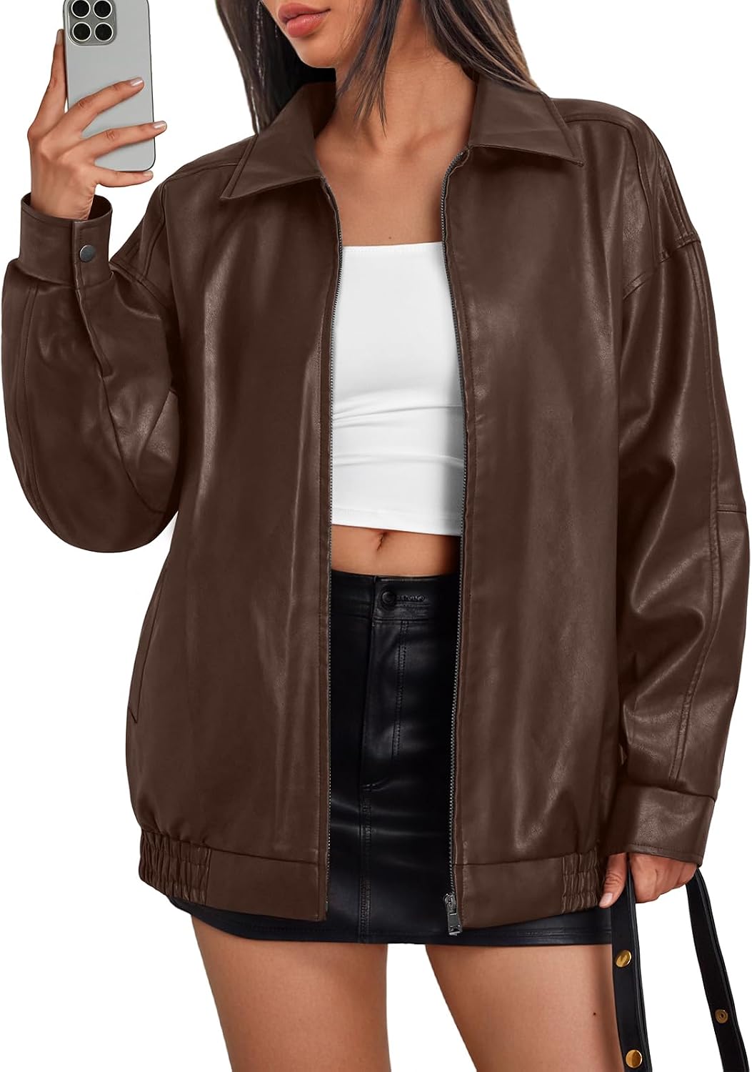 Brown oversized leather bomber jacket with a zip front, wide collar, and elastic hem