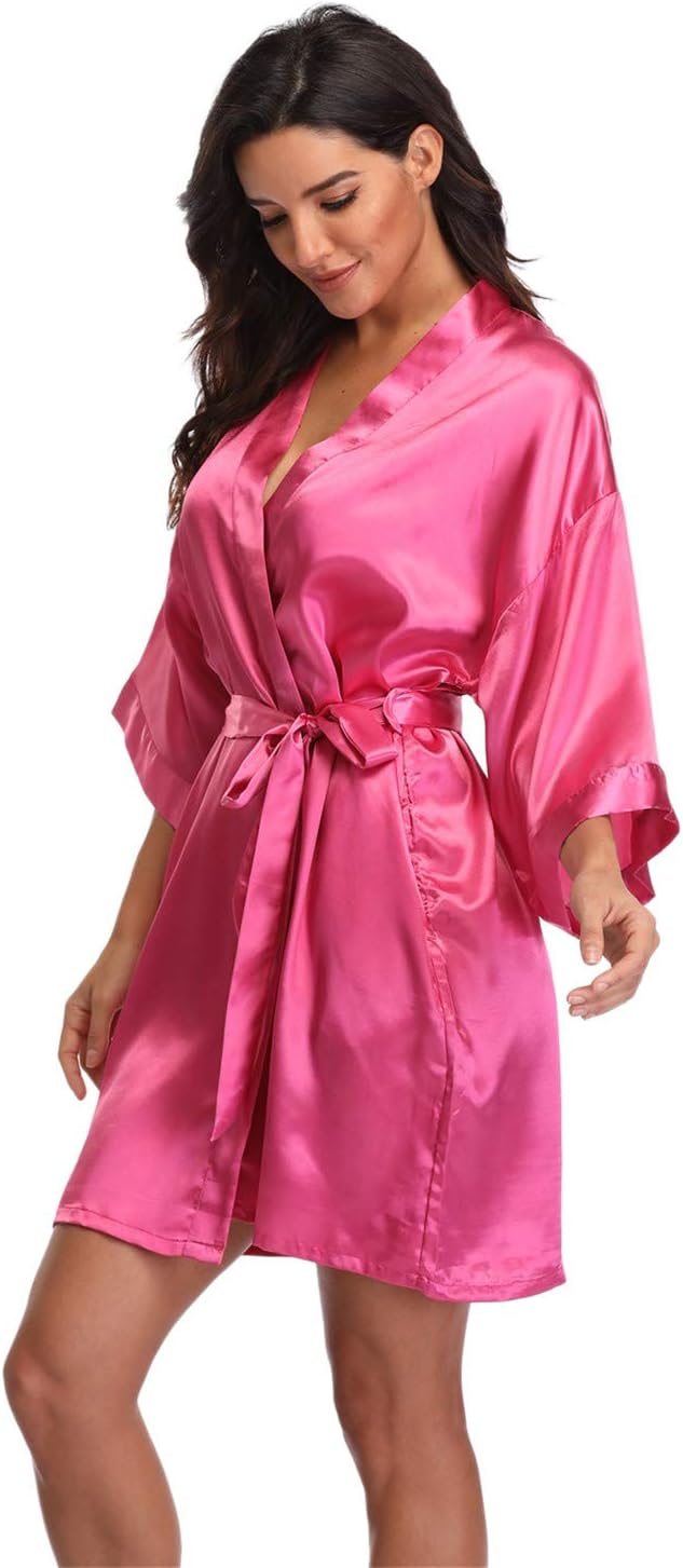 Women's bright pink satin robe with a wrap front, wide sleeves and tie belt