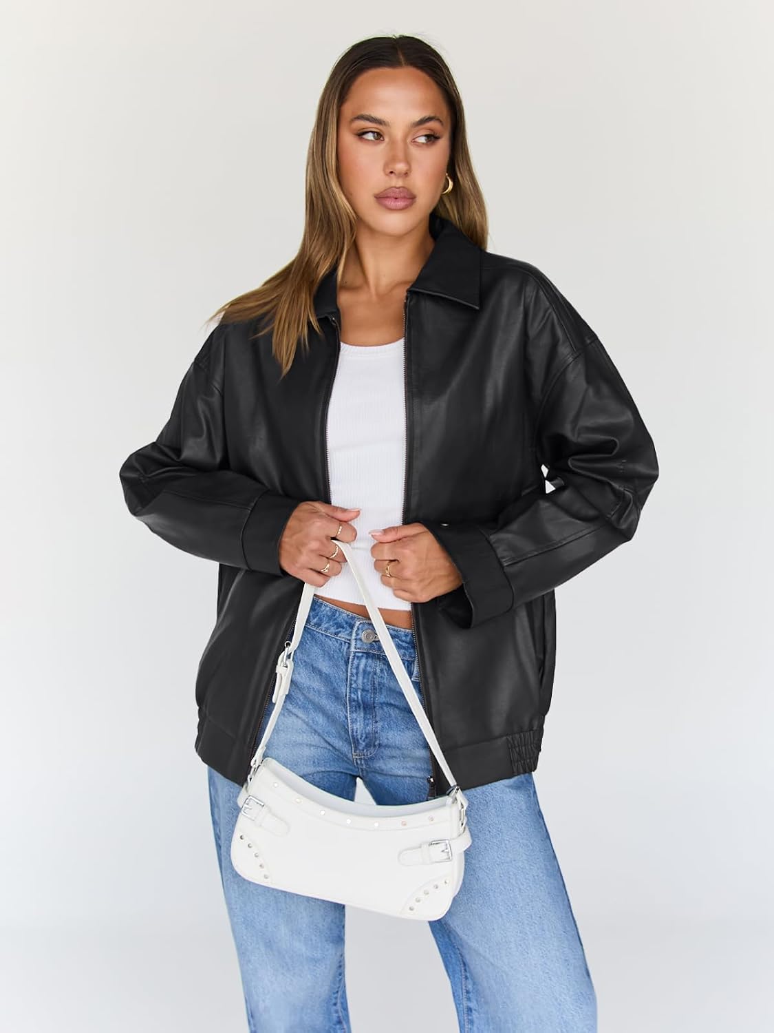 Black oversized leather bomber jacket with a wide collar, zip front and elastic hem