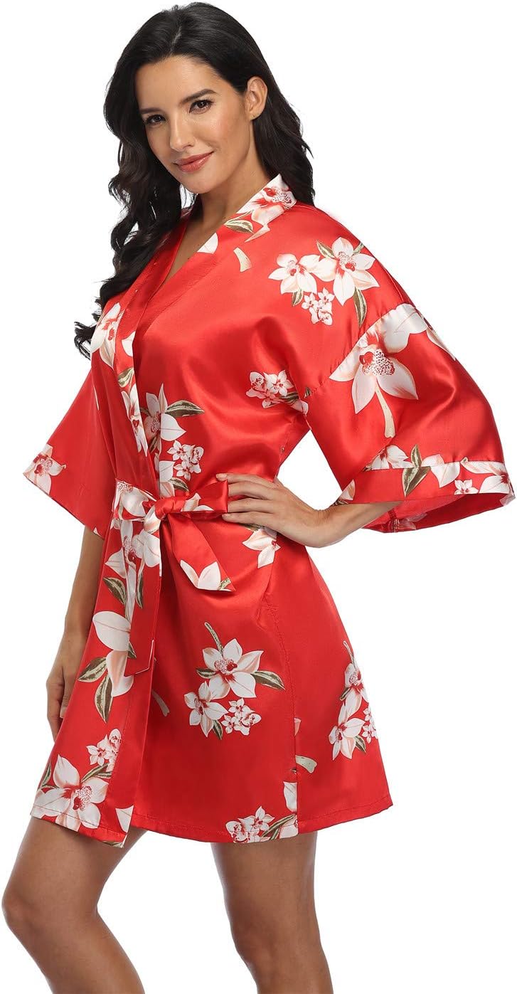Short red satin robe with white floral print, wide sleeves, and a matching tie belt