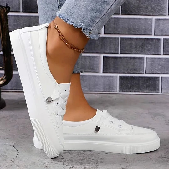 Women’s white chunky platform lace-up sneakers in faux leather, angled side view with thick sole.