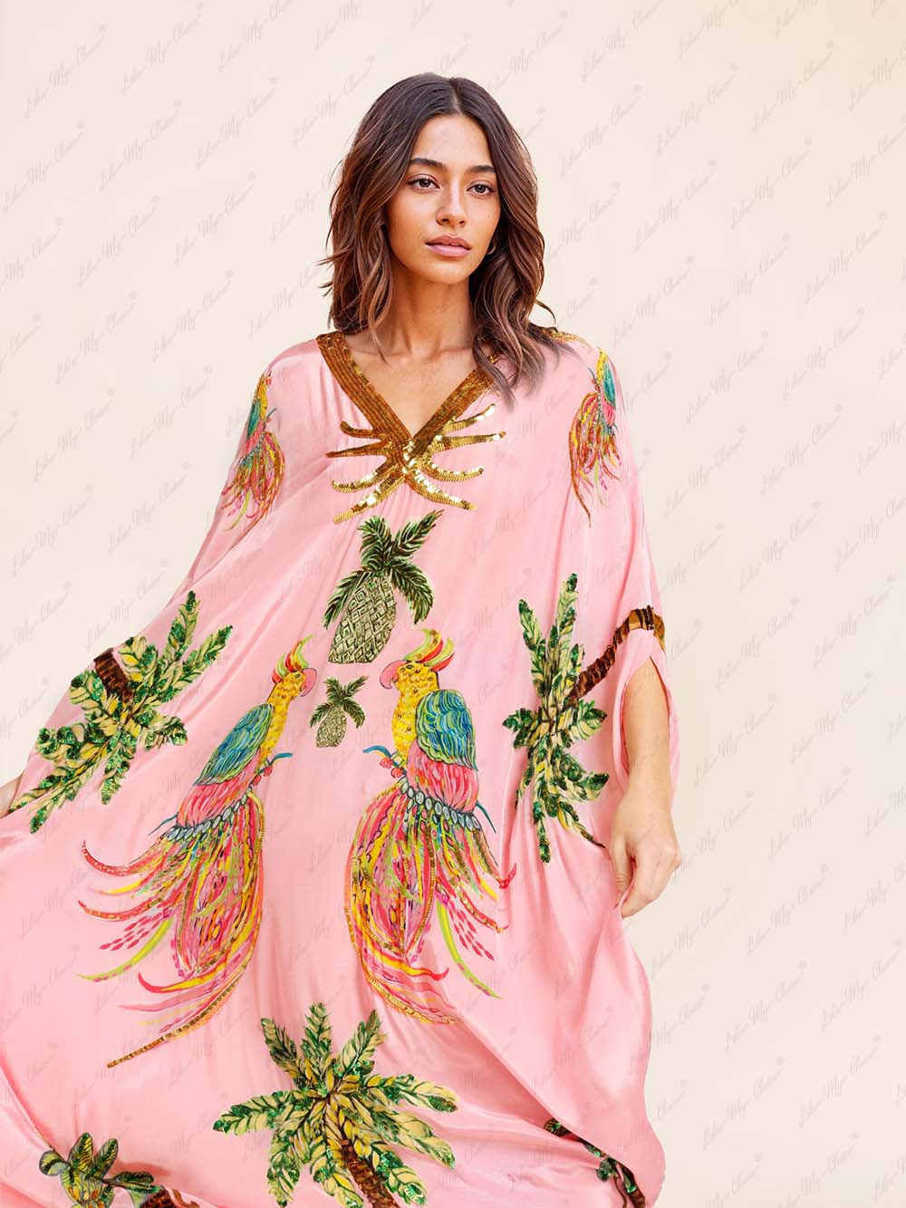 Pink tropical print kaftan maxi dress close-up: V-neck with gold sequin trim and birds.