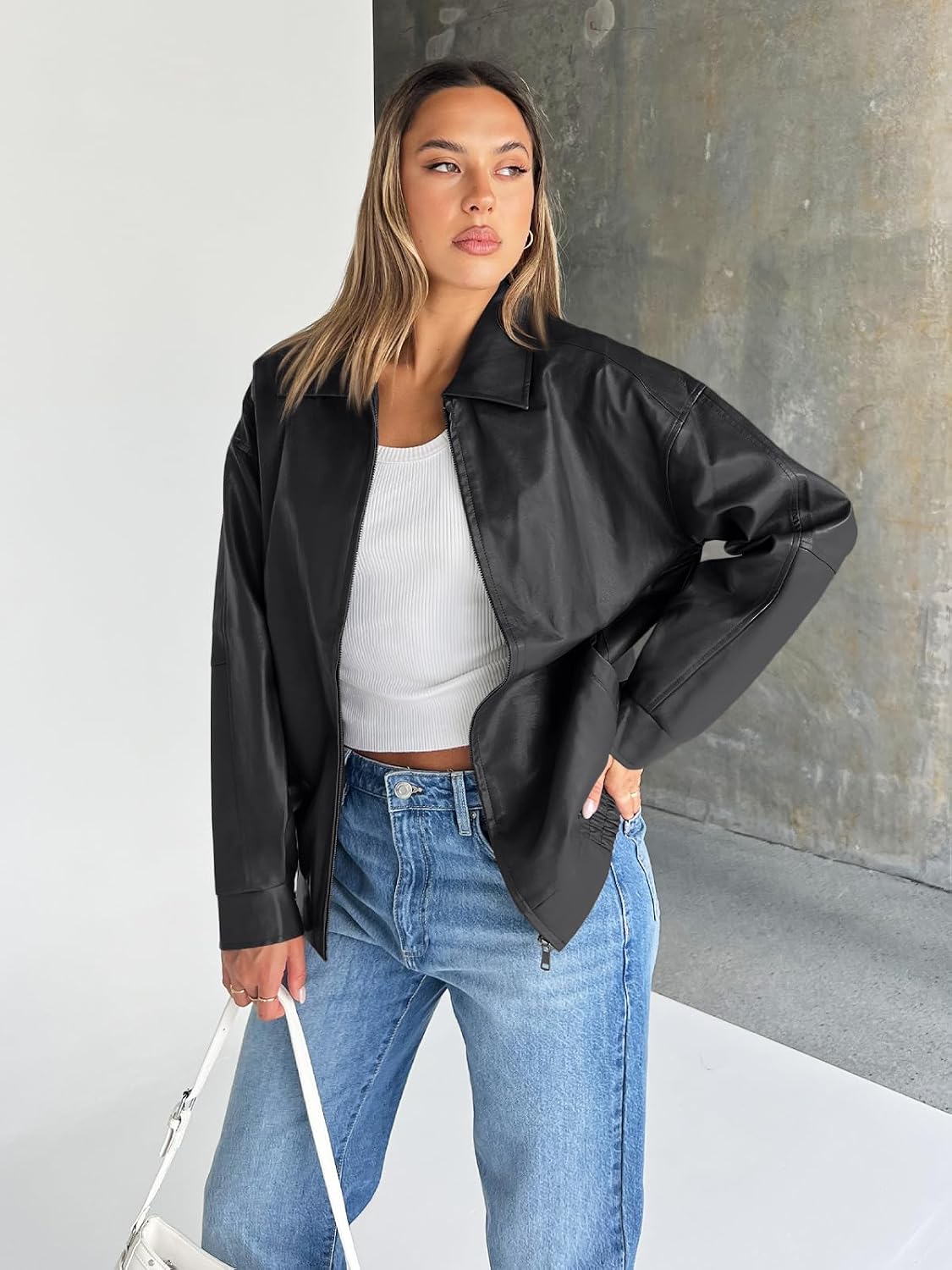 Black oversized leather jacket with a wide collar, zip front, and roomy sleeves