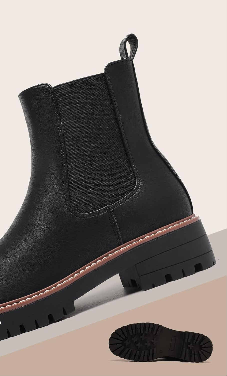 Black ankle boot with elastic side panel, contrast welt stitching, and chunky lug sole
