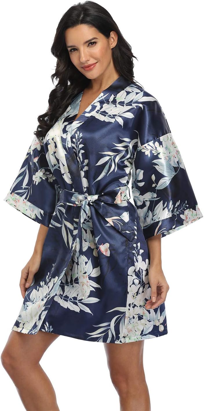 Short navy satin robe with white botanical print, wide sleeves, and a matching tie belt