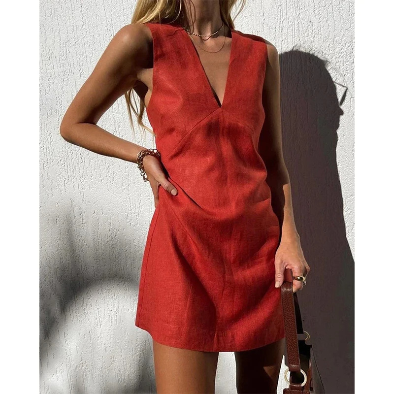 Sleeveless red mini dress with deep V neckline and curved seam panel detail